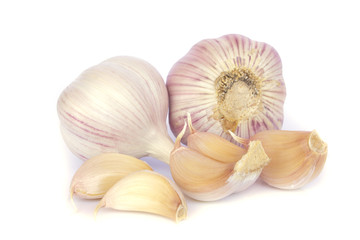 Garlic bulb and cloves on white background