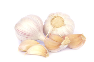 Garlic bulb and cloves on white background