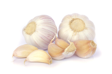 Garlic bulb and cloves on white background
