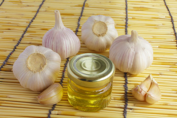 garlic bulbs and jar of honey as healthy eating