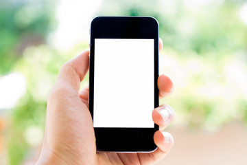 Close-up Hand holding smart phone with blurred nature background