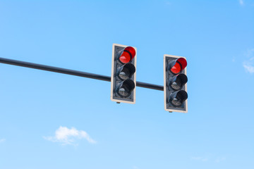 image of traffic light, the red light is lit. symbolic  for hold