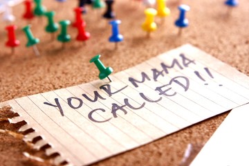 Message or reminder board with "your mama called" note