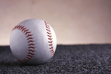 Softball on a gray mat