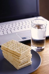 Soda Crackers, Glass of water and a computer