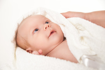cute happy little baby hidden in white towels