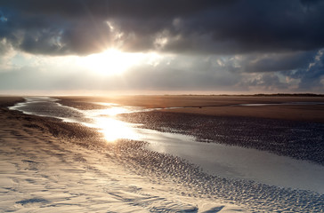 Obraz premium sunrise over sand beach on North sea