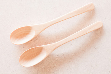 Top view of wooden spoons on brown background