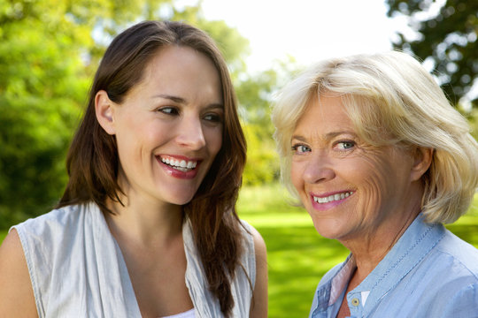 Senior mother smiling with older daughter