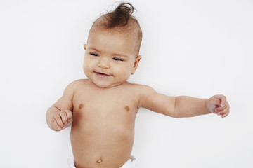 Six month old baby girl with mohican on white.
