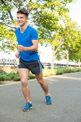 Young man running in park