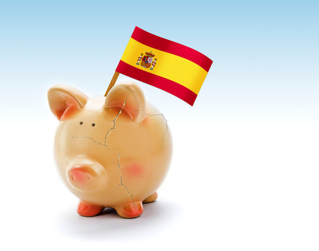 Piggy bank with cracks and national flag of Spain