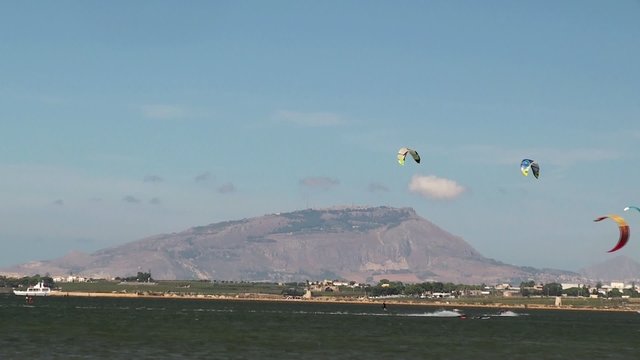 Kitesurfers and windsurfers in the Stagnone lagoon. Sicily