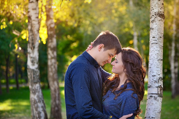 Fototapeta premium Portrait of romantic teenage couple sitting in park