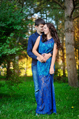 Young couple in love outdoor. They are smiling and looking at ea