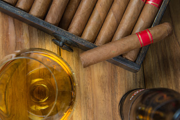 Cigars and Rum or alcohol on table