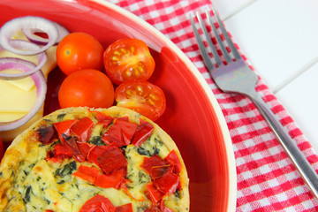 Close up Healthy lunch. Quiche, cheese, tomatoes, red onion