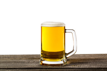 Beer glass with foam isolated on a vintage wooden table