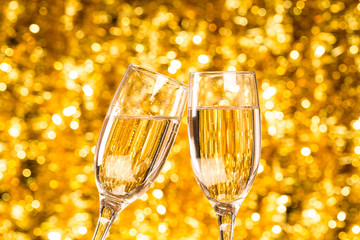 Two champagne glass on christmas bokeh background