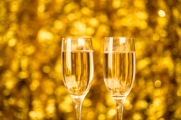 Two champagne glass on christmas bokeh background