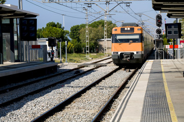 Modern orange train on station. Barcelona, Spain.