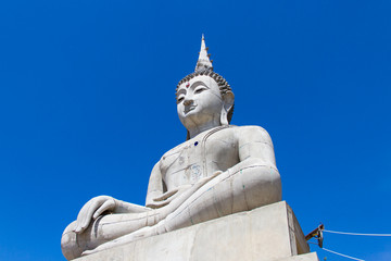 Buddha under construction and blue sky
