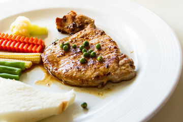 Pork steak with fresh green pepper grains