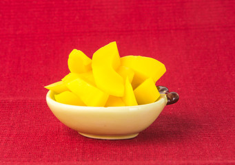 Fototapeta na wymiar preserved mango fruits Snack on a Background