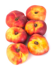 flat peaches (donut peaches) on a background