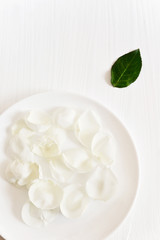 Elegant rose petals on white background