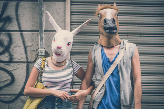 horse and rabbit mask couple of friends young  man and woman