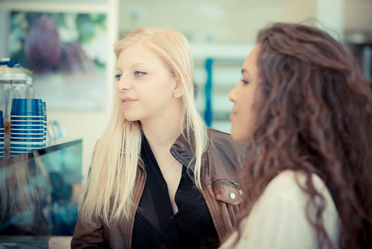 blonde and brunette beautiful stylish young women