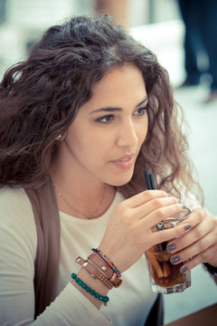 beautiful curly long brunette hair moroccan woman with cocktail
