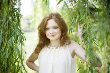 Portrait of redhead girl on nature