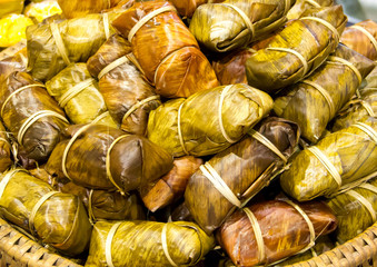 sticky rice covered in banana leaf