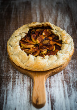 Apple pie on rustic wooden background