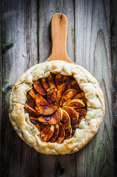 Apple pie on rustic wooden background