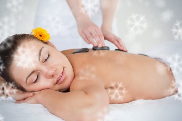 Obraz na płótnie Canvas Close up of a woman enjoying a hot stone massage