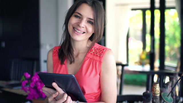 Happy beautiful woman with tablet computer at home