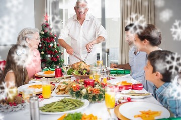 Extended family at dining table for christmas dinner in house