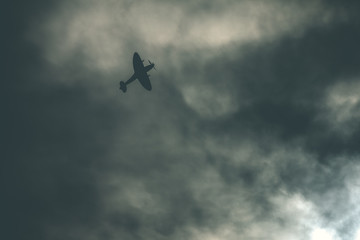 Fighter plane on cloudy sky