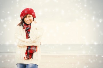 Cute smiling woman in stylish warm clothing at beach