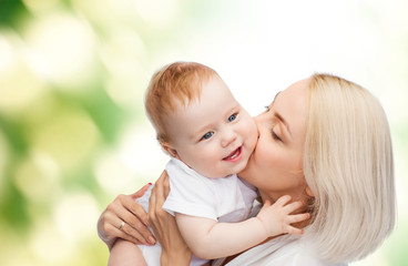 happy mother kissing smiling baby