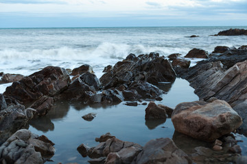Fototapeta na wymiar sharped stone in the sea or ocean foam wave