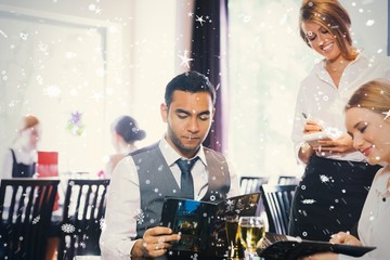 Composite image of two business people ordering dinner