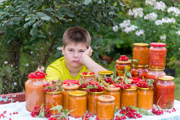 boy and home canned vegetables in nature