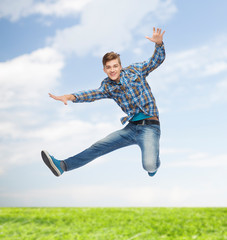 smiling young man jumping in air