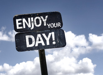 Enjoy Your Day sign with clouds and sky background