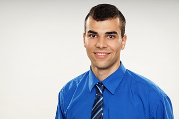 Portrait of young smiling man in blue shirt