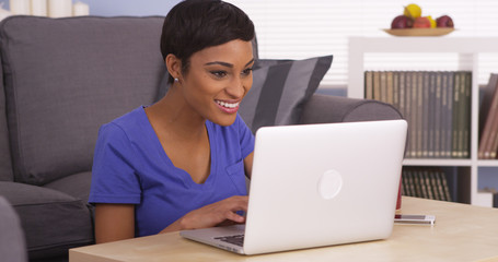 African woman happy using laptop